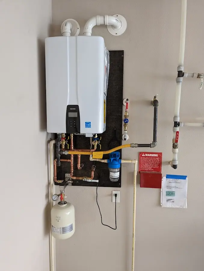 Professional plumber installing copper piping in a Shillington home